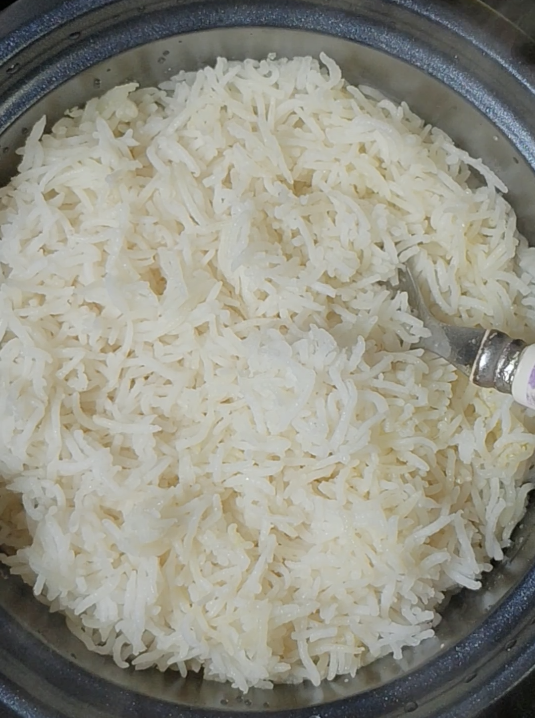 Freshly cooked fluffy basmati rice in a rice cooker