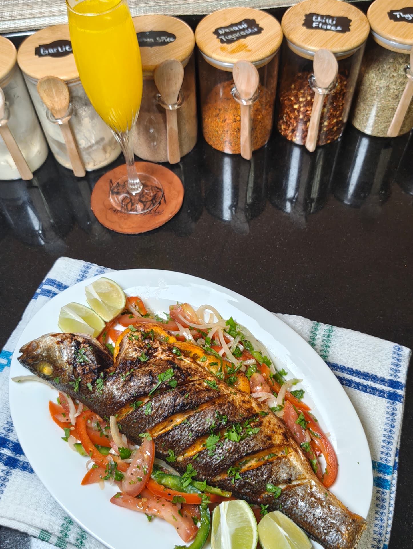 Whole sea bass cooked in an air fryer, served on a tomato, onion and coriander salad