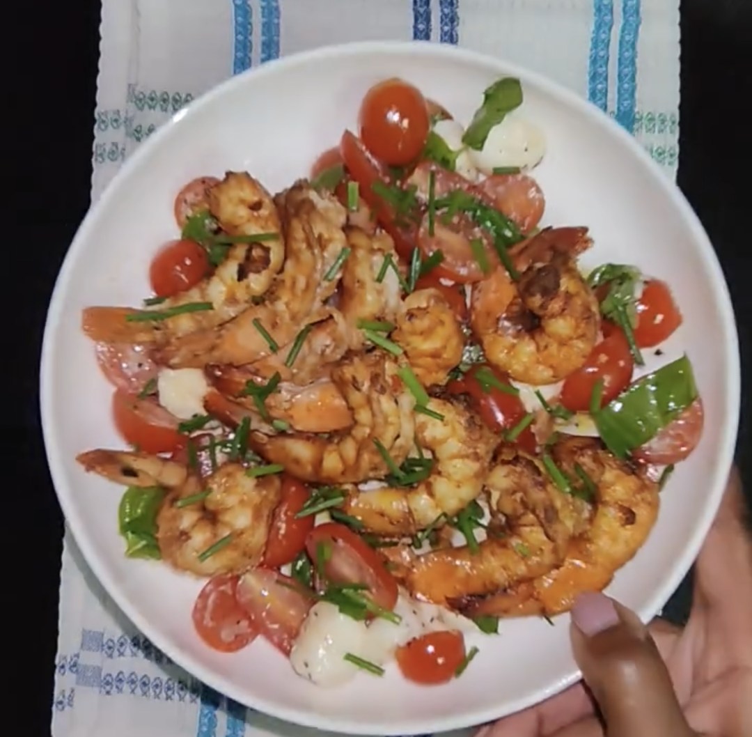 Finished air fryer shrimp served with a fresh salad, seen from above