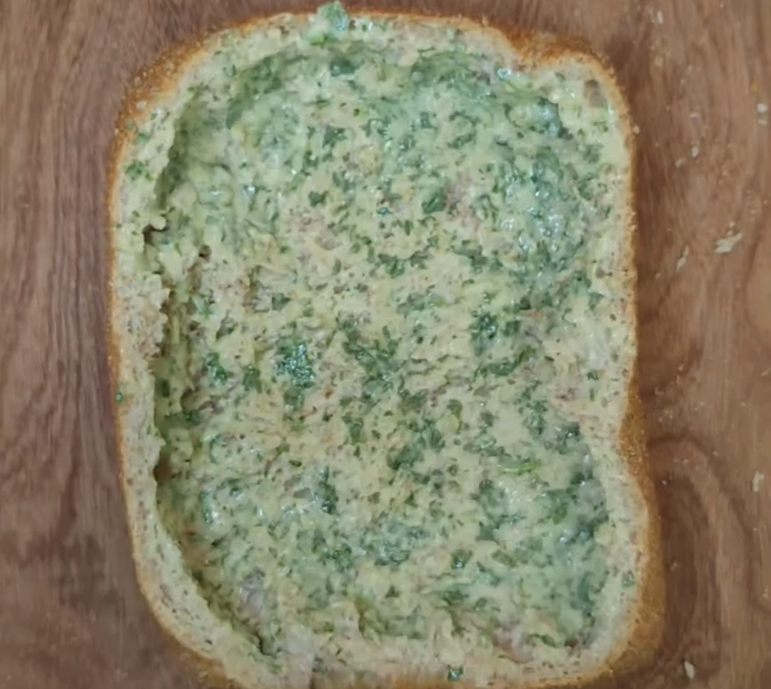 Country bread hollowed out and spread inside with garlic parsley butter paste